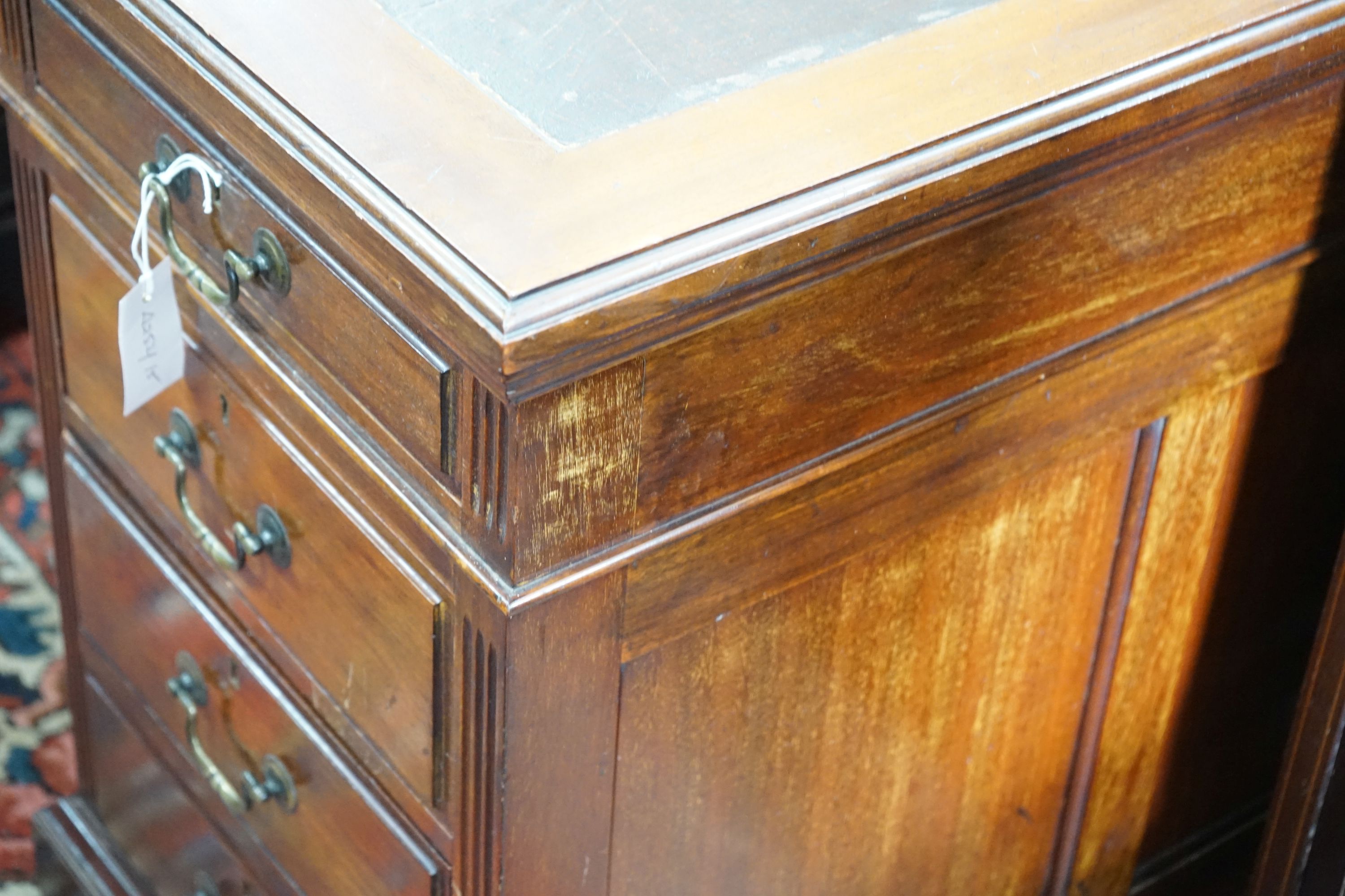 A reproduction Georgian style mahogany twin pedestal desk, fitted nine short drawers, on plinth base, width 152cm, depth 83cm, height 76cm